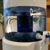 Aqualine 18 Waterfilter Glas – close-up van filter, pH-ring en mineraalstenen voor mineraalrijk en vitaliserend water.